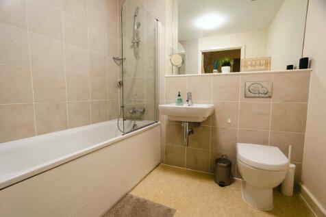 Modern bathroom suite featuring a clean bathtub...
