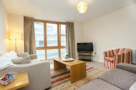 Bright and inviting living room featuring a lar...
