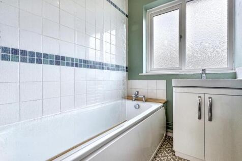 Bright and clean bathroom featuring a full-size...