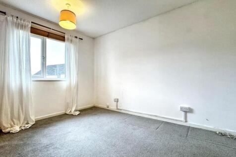 A bright and clean double bedroom featuring a l...