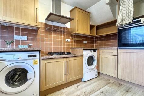 A well-maintained kitchen featuring wooden cabi...
