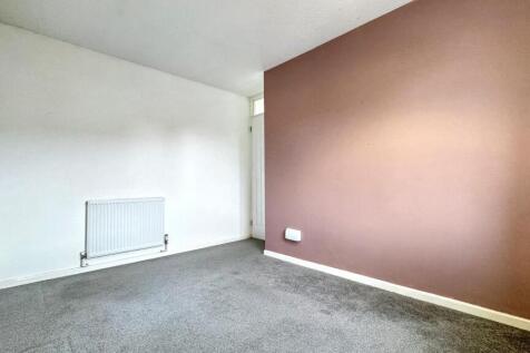 A clean and simple empty room with a neutral ca...