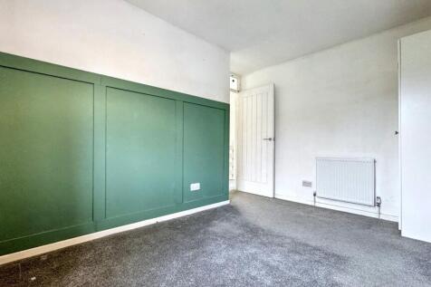 A simple, clean single bedroom featuring a fres...