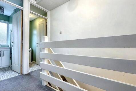 A bright and tidy hallway featuring a modern wh...