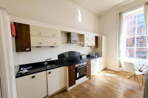 Bright and modern kitchen space featuring sleek...
