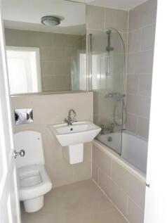 Bright and modern bathroom featuring a clean wh...