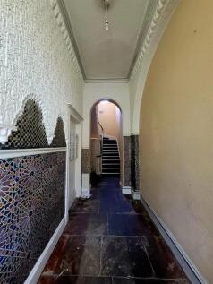A charming hallway featuring decorative tiled w...