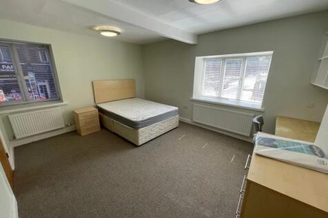 A bright and spacious double bedroom featuring ...