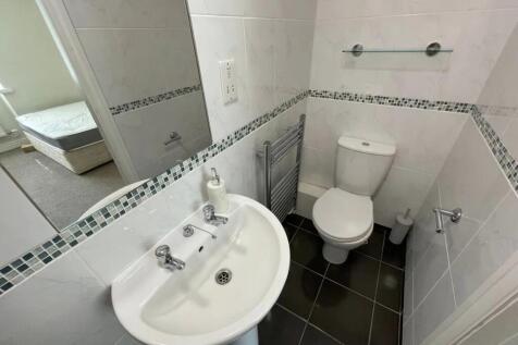 Bright and clean small toilet room featuring mo...