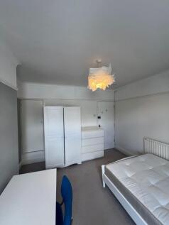 A simple and tidy single bedroom featuring a cl...