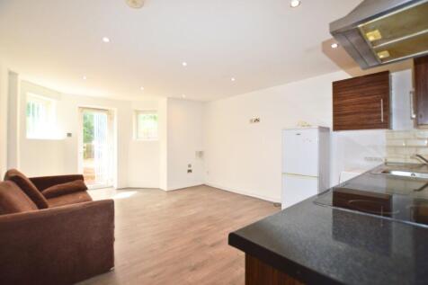 A bright and clean living space with modern woo...