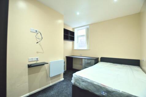 A neat and modern single bedroom featuring a co...
