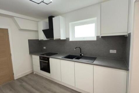A modern and sleek kitchen featuring clean whit...