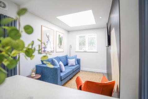 Bright and modern living room featuring a cozy ...