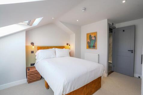 A stylish double bedroom featuring a comfortabl...