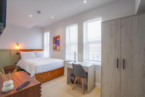 A bright and modern double bedroom featuring a ...