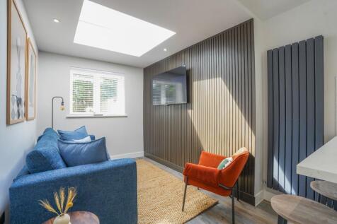A stylish living room featuring a cozy blue sof...