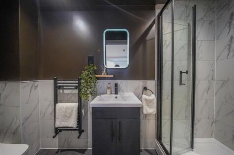 A modern bathroom featuring a sleek black and w...