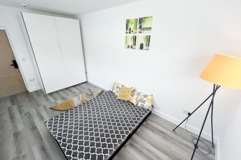 A bright and modern double bedroom featuring a ...