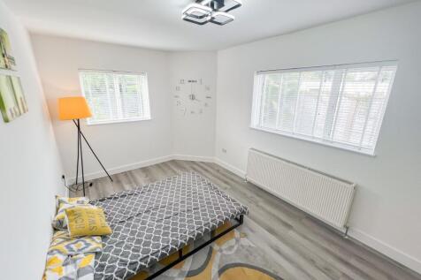 Bright and clean single bedroom featuring conte...