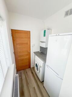 A bright and tidy utility storage area featurin...