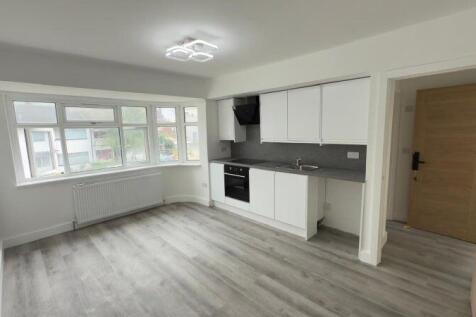 A bright and modern kitchen space featuring sle...