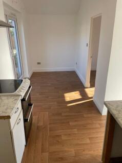 Bright and clean kitchen area with natural sunl...