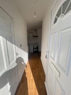 A bright and clean hallway featuring warm woode...