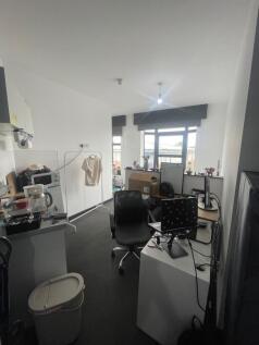A compact and functional room featuring a works...
