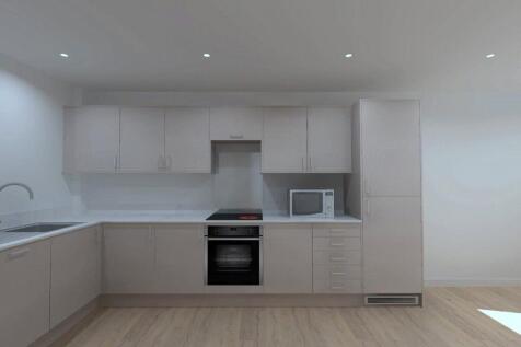 A modern, clean kitchen featuring sleek cabinet...