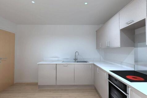 A modern and clean kitchen featuring sleek whit...