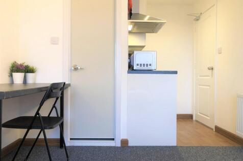 A bright and tidy communal workspace featuring ...