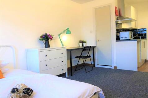 Bright single bedroom featuring a tidy study ar...