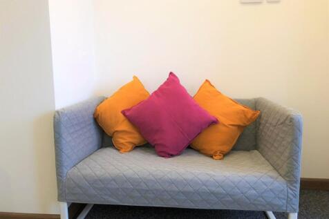 A cozy communal lounge area featuring a modern ...