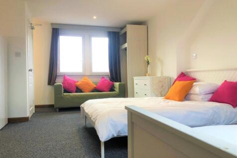 Bright and welcoming double bedroom featuring a...
