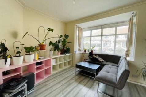 Bright and modern living room featuring a large...
