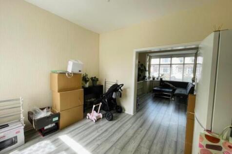 A bright living room with light wooden flooring...