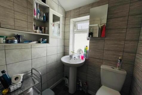 Bright and tidy bathroom featuring modern tilin...