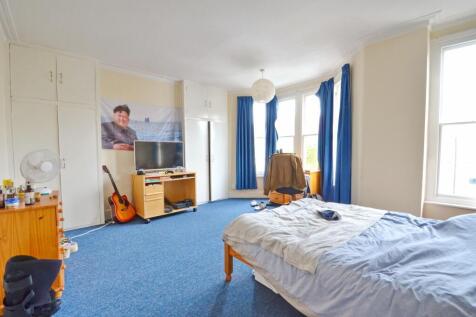 Spacious and bright master bedroom featuring a ...