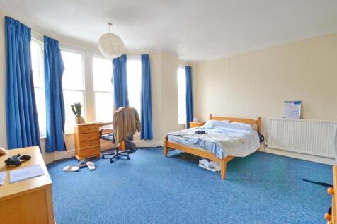 Bright and spacious double bedroom featuring la...