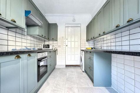 Bright and modern kitchen featuring sleek cabin...