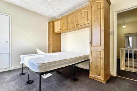 Bright double bedroom featuring a large built-i...