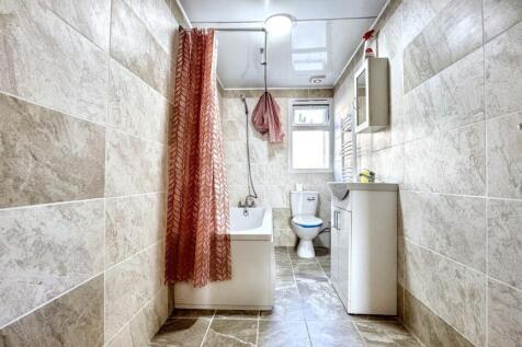 Bright and modern bathroom featuring stylish ti...