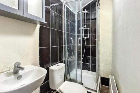 Modern bathroom featuring a shower with glass d...