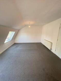 A clean and simple room with neutral walls and ...
