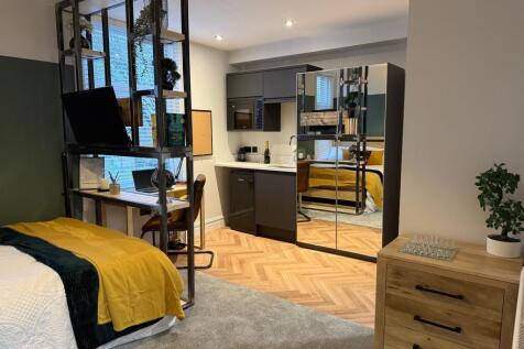 A stylish master bedroom featuring a cozy doubl...