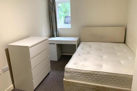 A clean and simple double bedroom featuring a c...