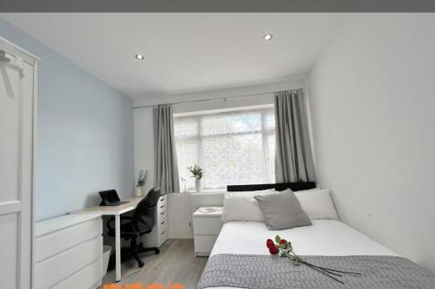 A bright and inviting double bedroom with a nea...