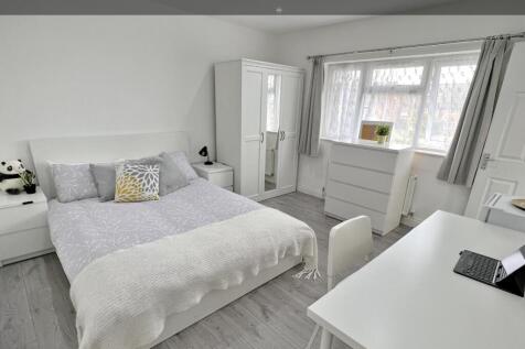Bright and spacious master bedroom featuring a ...