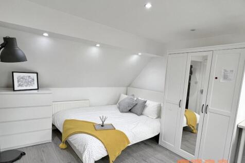 Bright and modern double bedroom featuring a co...